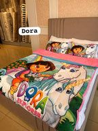 A colorful Dora the Explorer themed bedding set on a bed, featuring a duvet cover and matching pillowcases with illustrations of Dora and a unicorn. The word 'Dora' is displayed as an overlay label.